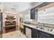 Kitchen with granite countertops, stainless steel sink, dark wood cabinets and open to hardwood floor dining area at 6046 River Rd, New Port Richey, FL 34652