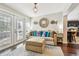 Bright sitting room boasts hardwood floors, stylish decor, and seamless flow into the adjacent kitchen at 6046 River Rd, New Port Richey, FL 34652