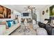 Spacious living room boasts travertine floors, a ceiling fan, stylish decor, and a staircase to the upper level at 6046 River Rd, New Port Richey, FL 34652