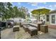 Spacious patio area with outdoor seating, a fire pit, and an umbrella providing a relaxing outdoor living space at 6046 River Rd, New Port Richey, FL 34652