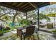 Scenic outdoor space with a dining area, seating, lush foliage, and shaded areas, creating a tranquil retreat at 6046 River Rd, New Port Richey, FL 34652