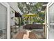 Outdoor patio with comfortable seating, a table, and surrounding greenery, perfect for enjoying the serene outdoor space at 6046 River Rd, New Port Richey, FL 34652
