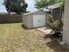 Metal storage shed on a grassy lot with wooden fence in the background at 6108 Maplewood Dr, New Port Richey, FL 34653