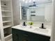 Elegant bathroom with a double sink vanity, modern fixtures, and beautiful wall tile at 6108 Maplewood Dr, New Port Richey, FL 34653
