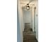 Hallway featuring luxury vinyl flooring and doors leading to the bedrooms at 6108 Maplewood Dr, New Port Richey, FL 34653