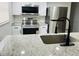 Kitchen boasting stainless steel appliances, granite countertops, white cabinetry, and undermount sink at 6108 Maplewood Dr, New Port Richey, FL 34653