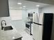 Bright kitchen showcasing stainless steel appliances, a subway tile backsplash, and ample cabinet space at 6108 Maplewood Dr, New Port Richey, FL 34653