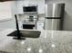 Kitchen with granite countertops and stainless-steel appliances at 6108 Maplewood Dr, New Port Richey, FL 34653