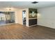 Bright living room with new floors, modern accent wall, and sliding glass doors to backyard at 6108 Maplewood Dr, New Port Richey, FL 34653