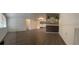 Bright living room with new floors, a modern mirror, and sliding glass doors at 6108 Maplewood Dr, New Port Richey, FL 34653