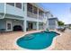Spacious backyard featuring a private pool, covered patio, spiral staircase, and direct access to outdoor entertainment spaces at 6140 Seaside Dr, New Port Richey, FL 34652