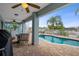Backyard pool area with a covered patio, a spiral staircase, and a fenced-in pool at 6140 Seaside Dr, New Port Richey, FL 34652