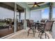 Outdoor patio with a ceiling fan, a table with seating and a view of the surrounding area at 6140 Seaside Dr, New Port Richey, FL 34652
