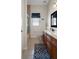 Bathroom featuring a vanity with wood cabinets, neutral walls and floors, and a shower stall that maximizes space and functionality at 6140 Seaside Dr, New Port Richey, FL 34652