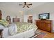 Bright bedroom featuring a ceiling fan, wooden furniture, and view through a doorway at 6140 Seaside Dr, New Port Richey, FL 34652
