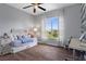 Bedroom featuring stylish wood-look flooring, a daybed with cozy bedding, and a large window offering natural light at 6140 Seaside Dr, New Port Richey, FL 34652