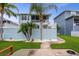 Back of house, with a well-manicured lawn and path to the waterfront at 6140 Seaside Dr, New Port Richey, FL 34652