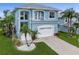 Charming two-story home featuring a front-facing two-car garage and a small balcony at 6140 Seaside Dr, New Port Richey, FL 34652