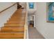 Bright foyer featuring hardwood stairs, tile flooring, and views into the living area at 6140 Seaside Dr, New Port Richey, FL 34652