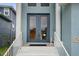 Inviting front entrance with double doors, white railings, and decorative plants at 6140 Seaside Dr, New Port Richey, FL 34652
