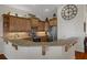 Well-lit kitchen featuring stainless steel appliances, granite countertops, and wooden cabinets at 6140 Seaside Dr, New Port Richey, FL 34652