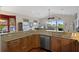 Kitchen with granite countertops, stainless steel appliances, and a view of the living room at 6140 Seaside Dr, New Port Richey, FL 34652