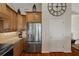 Kitchen with stainless steel appliances, wooden cabinets, and granite countertops at 6140 Seaside Dr, New Port Richey, FL 34652