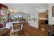 Open living area with hardwood floors, dining table, kitchen with island, and waterfront views through large windows at 6140 Seaside Dr, New Port Richey, FL 34652