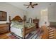 Bedroom with a large bed, tropical-themed bedding, wood flooring, and an ensuite bathroom at 6140 Seaside Dr, New Port Richey, FL 34652