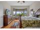 Bedroom with a large bay window, tropical bedding and wood flooring at 6140 Seaside Dr, New Port Richey, FL 34652