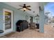 Outdoor patio space with ceiling fans, grill, and seating for entertaining, plus spiral staircase to upper level at 6140 Seaside Dr, New Port Richey, FL 34652