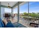 Spacious screened-in patio with comfortable seating, table, and serene waterfront views at 6140 Seaside Dr, New Port Richey, FL 34652