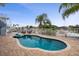 Private outdoor pool with brick patio, white fence, mature landscaping, and seating for relaxing and enjoying the Florida sunshine at 6140 Seaside Dr, New Port Richey, FL 34652