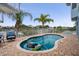 Inviting kidney-shaped pool with surrounding brick patio, white fence, and lounge seating for relaxation and enjoyment at 6140 Seaside Dr, New Port Richey, FL 34652