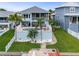 Beautiful rear exterior features an outdoor pool, patio, and lush green lawn at 6140 Seaside Dr, New Port Richey, FL 34652