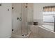 Modern shower featuring glass enclosure, tiled walls, and rainfall shower head at 6140 Seaside Dr, New Port Richey, FL 34652