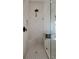 Bathroom shower with light tile and glass door at 6140 Seaside Dr, New Port Richey, FL 34652