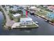 Aerial shot of waterfront home with boat lift, set on canal, surrounded by tropical landscaping at 6322 Aureau Ave, Hudson, FL 34667