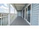 Charming balcony overlooking the water, featuring white railings and access to the interior through glass doors at 6322 Aureau Ave, Hudson, FL 34667