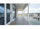 Inviting balcony with scenic water views, showcasing a gray wood deck and white railing at 6322 Aureau Ave, Hudson, FL 34667