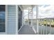Balcony view with gray wood deck, white railing, and spiral staircase at 6322 Aureau Ave, Hudson, FL 34667