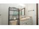 Bathroom with wood trim, toilet, vanity, shelving unit and tri-fold mirror cabinet at 6322 Aureau Ave, Hudson, FL 34667