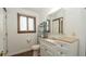 Bathroom with wood trim window, toilet, vanity and tri-fold mirror cabinet at 6322 Aureau Ave, Hudson, FL 34667
