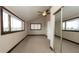 Bedroom with a large window, carpet flooring, ceiling fan and mirrored closet at 6322 Aureau Ave, Hudson, FL 34667