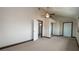 Bedroom with neutral carpet, ceiling fan, closet with mirrored doors and bathroom access at 6322 Aureau Ave, Hudson, FL 34667
