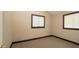 Neutral bedroom with carpet flooring, wood trim and two windows at 6322 Aureau Ave, Hudson, FL 34667