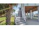Exterior staircase leads up to home elevated on stilts with canal access at 6322 Aureau Ave, Hudson, FL 34667