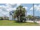 Exterior view of home with stairs and palm trees, plus boat parking at 6322 Aureau Ave, Hudson, FL 34667