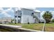 Exterior view of raised home with stairs and boat parking underneath at 6322 Aureau Ave, Hudson, FL 34667