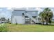 Exterior view of home with stairs and boat parking underneath at 6322 Aureau Ave, Hudson, FL 34667